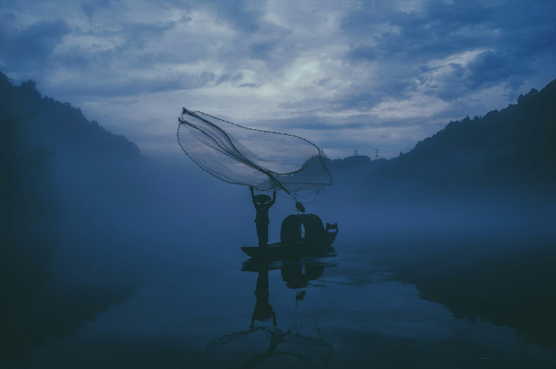 Premium JDK fishing rod and reel on wet stone at dawn